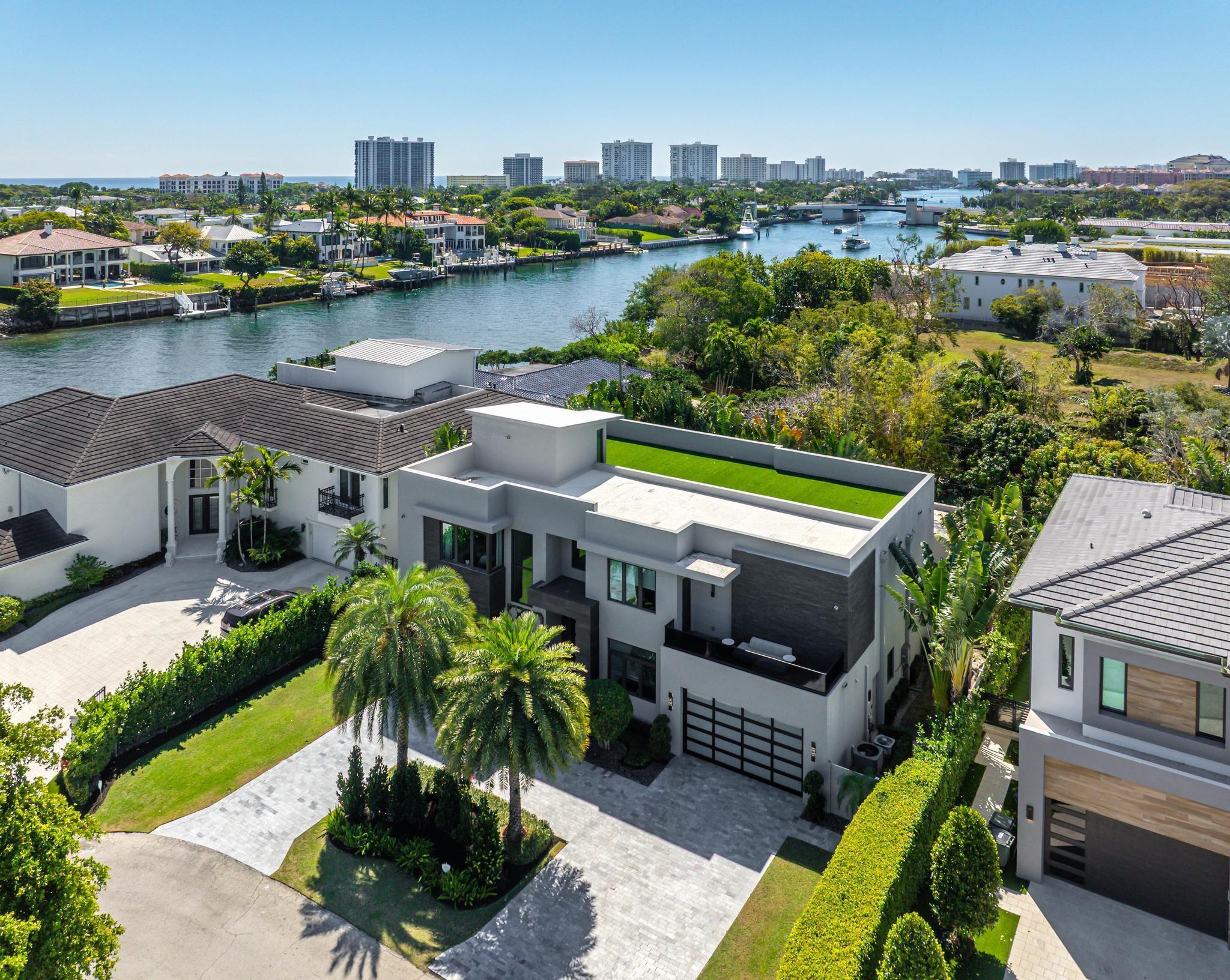 520 Northeast 4th Lane Boca Raton, FL 33432 - Photo 4 of 40 a view of a swimming pool with a patio and a garden