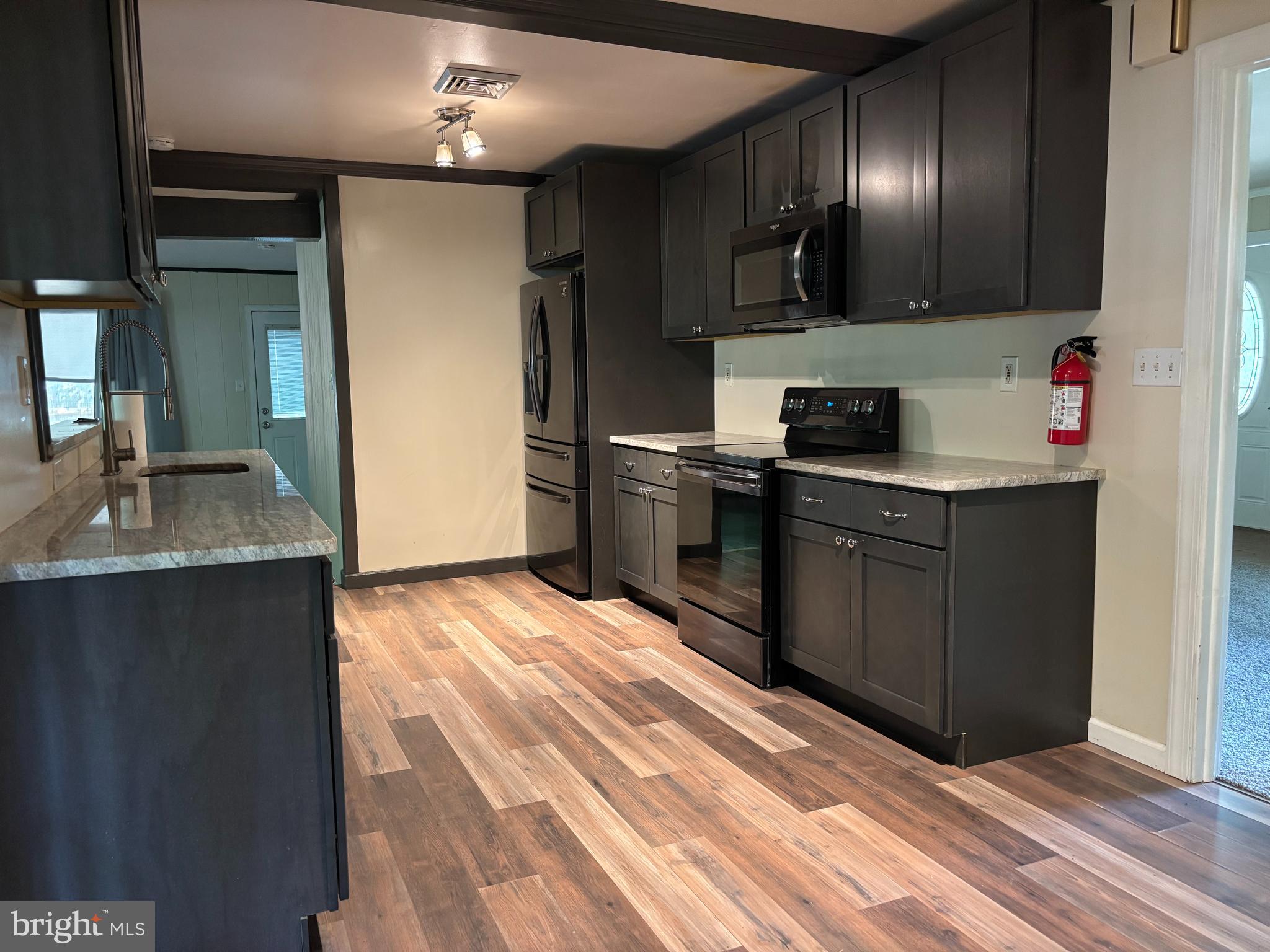 3 Cedar Trail Medford, NJ 08055 - Photo 4 of 22 a kitchen with granite countertop a sink and cabinets