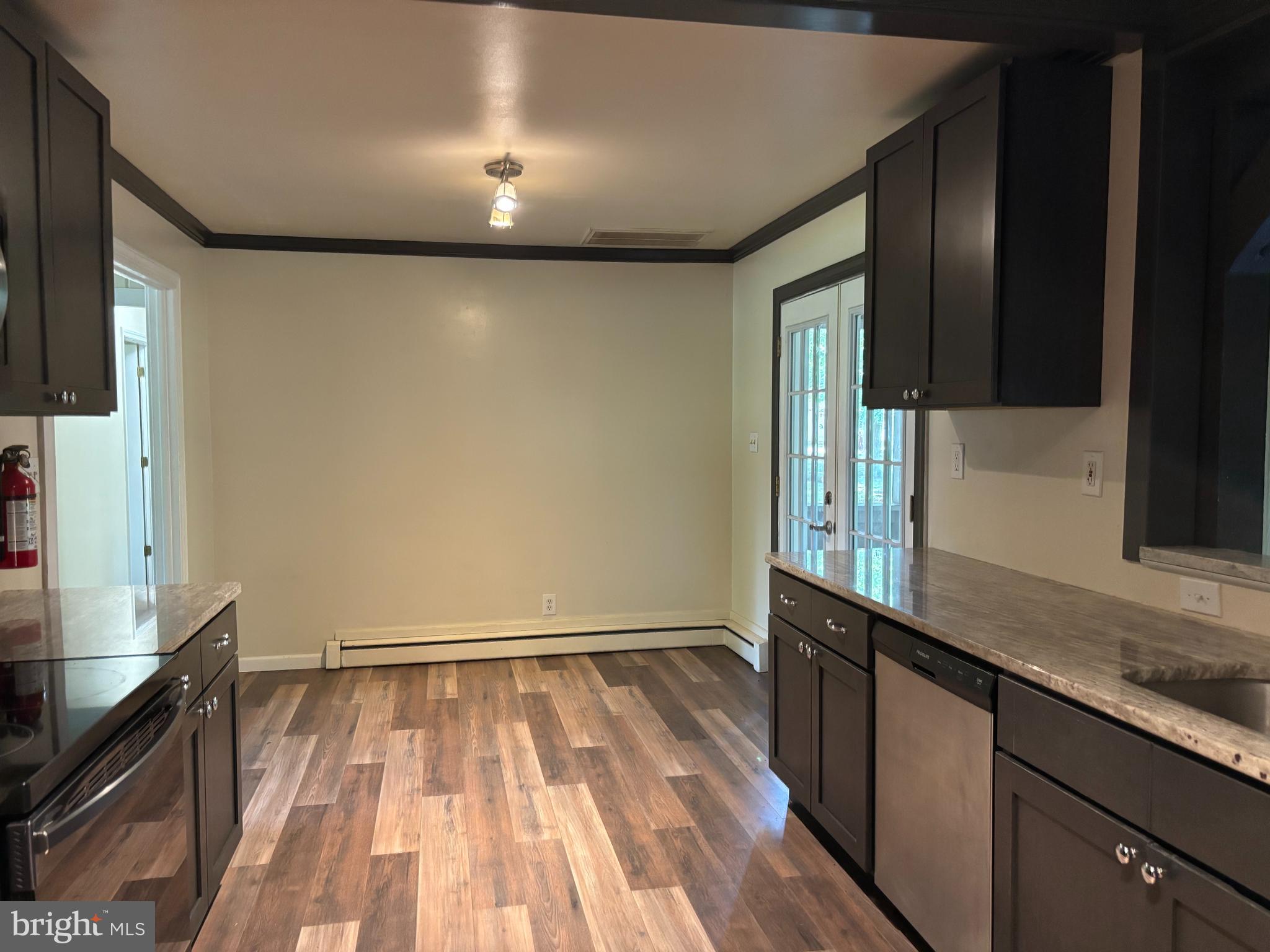 3 Cedar Trail Medford, NJ 08055 - Photo 5 of 22 a kitchen with granite countertop white cabinets and black appliances