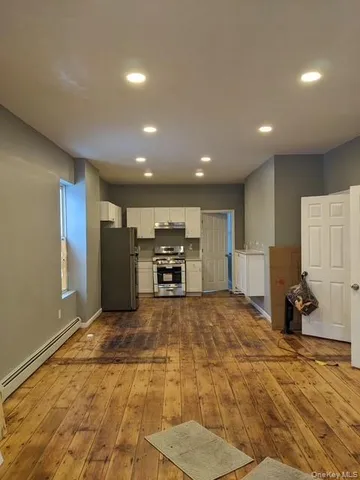 a view of a kitchen with a sink and a refrigerator