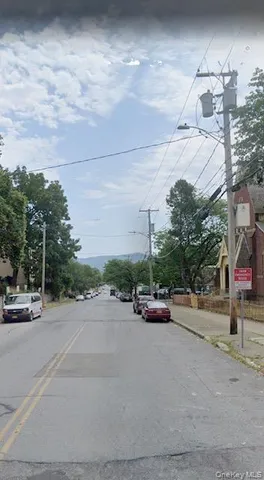 a view of street with parked cars