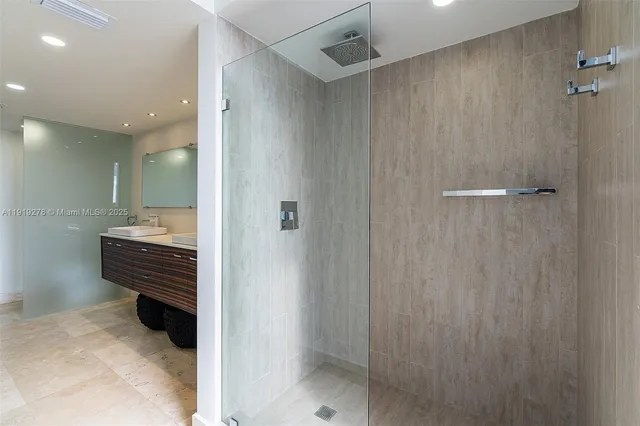 a bathroom with a shower and a sink