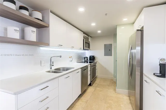 a kitchen with a sink cabinets and stainless steel appliances