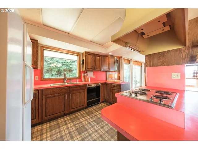 a kitchen with stainless steel appliances kitchen island granite countertop a refrigerator stove and sink