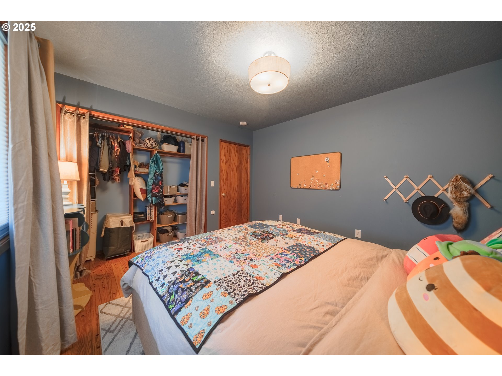 92693 T T Larson Road Astoria, OR 97103 - Photo 23 of 40 a bedroom with a bed and dresser with mirror