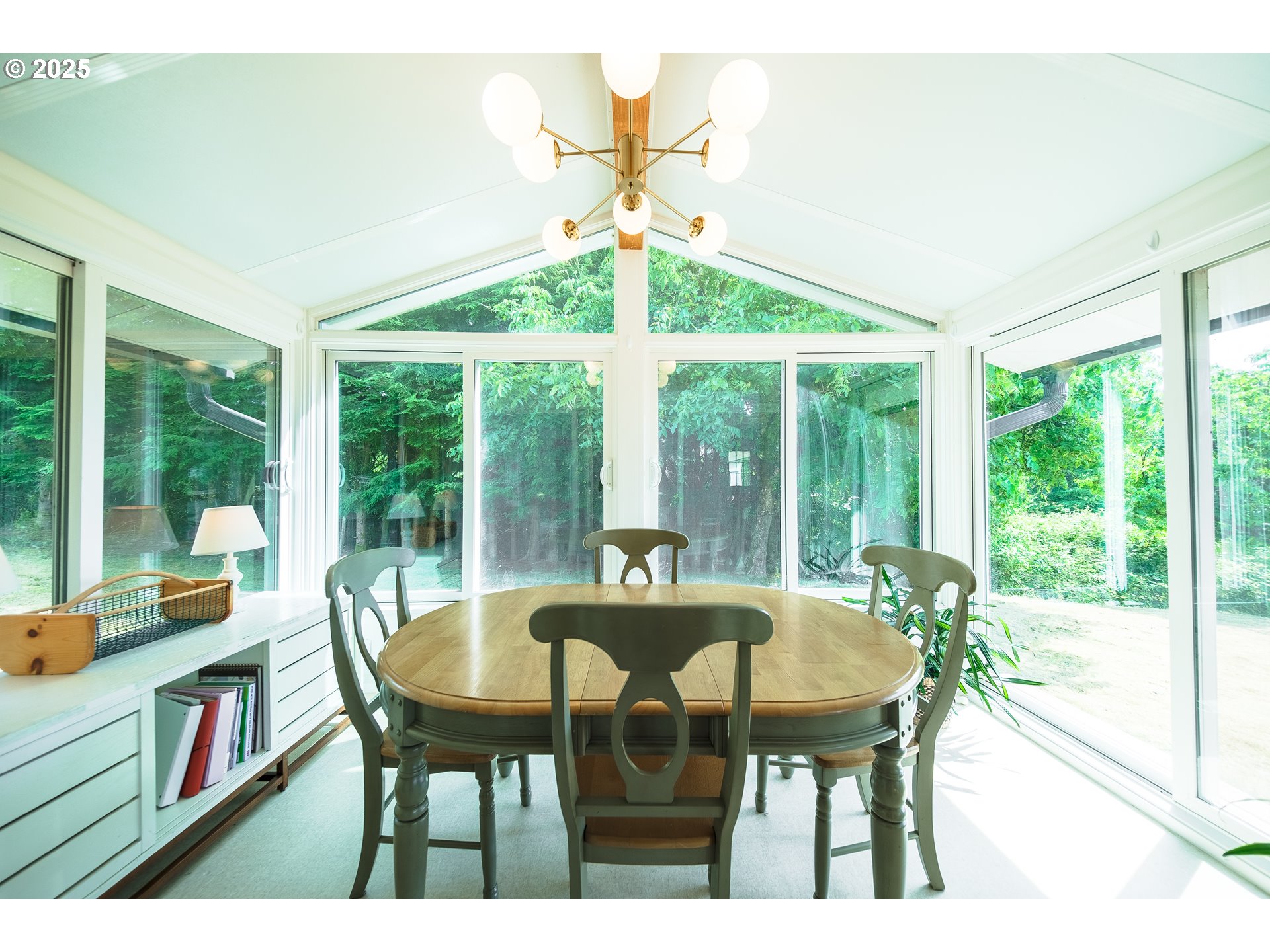 92693 T T Larson Road Astoria, OR 97103 - Photo 10 of 40 a view of a dining room with furniture large windows and wooden floor