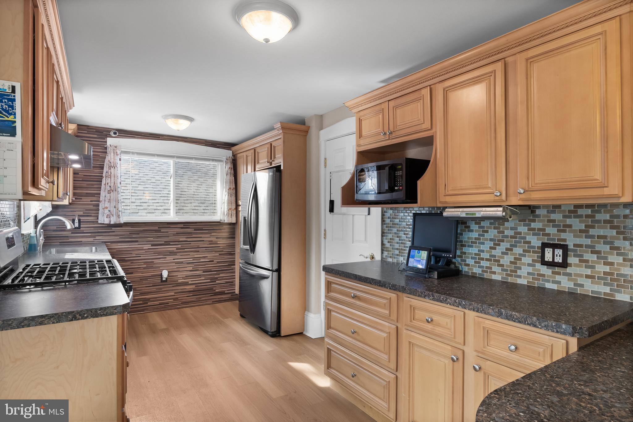 116 Fairmount Avenue Voorhees, NJ 08043 - Photo 11 of 37 a kitchen with granite countertop a stove and a refrigerator