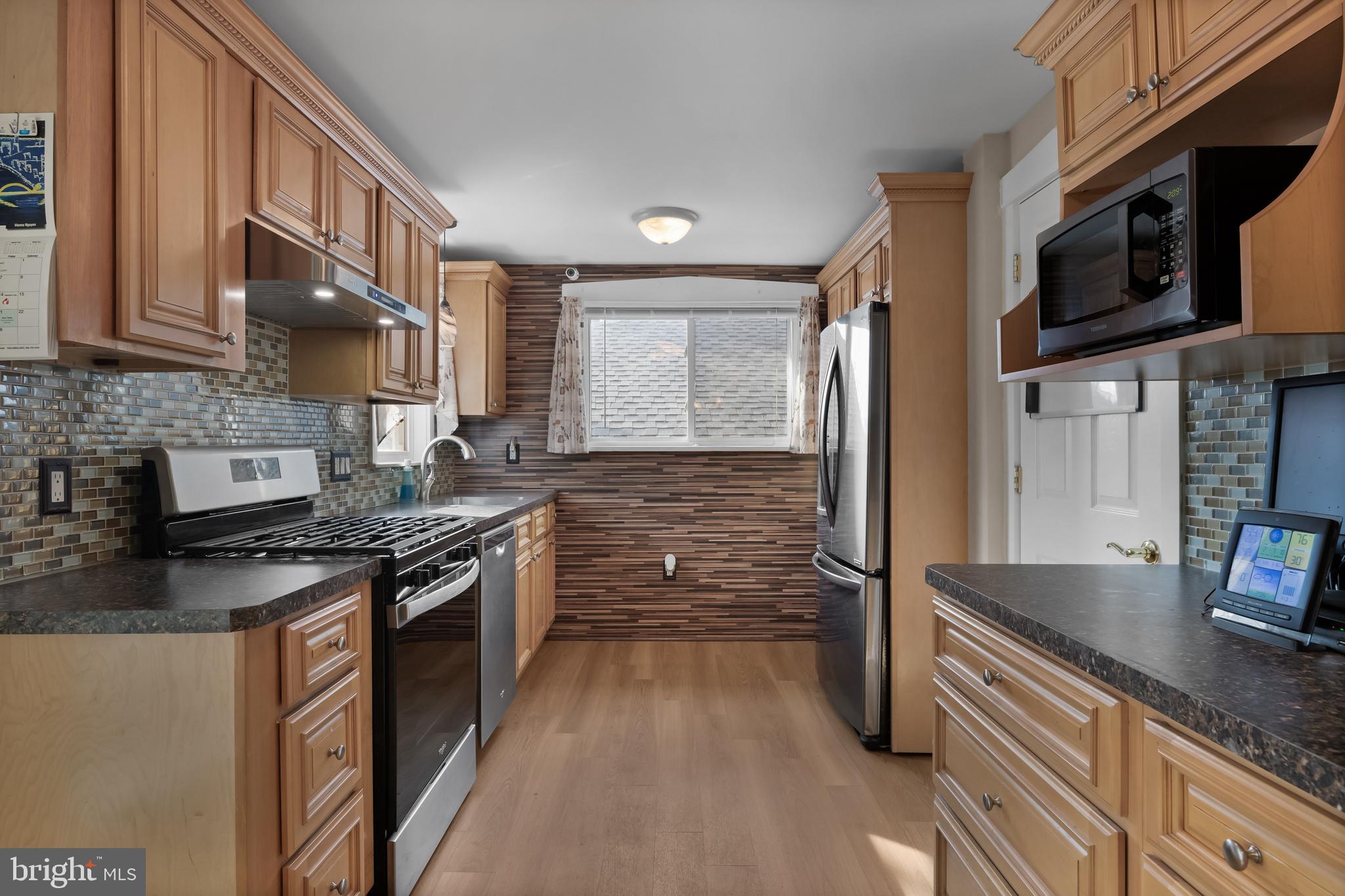 116 Fairmount Avenue Voorhees, NJ 08043 - Photo 12 of 37 a kitchen with stainless steel appliances granite countertop a stove a sink and a microwave