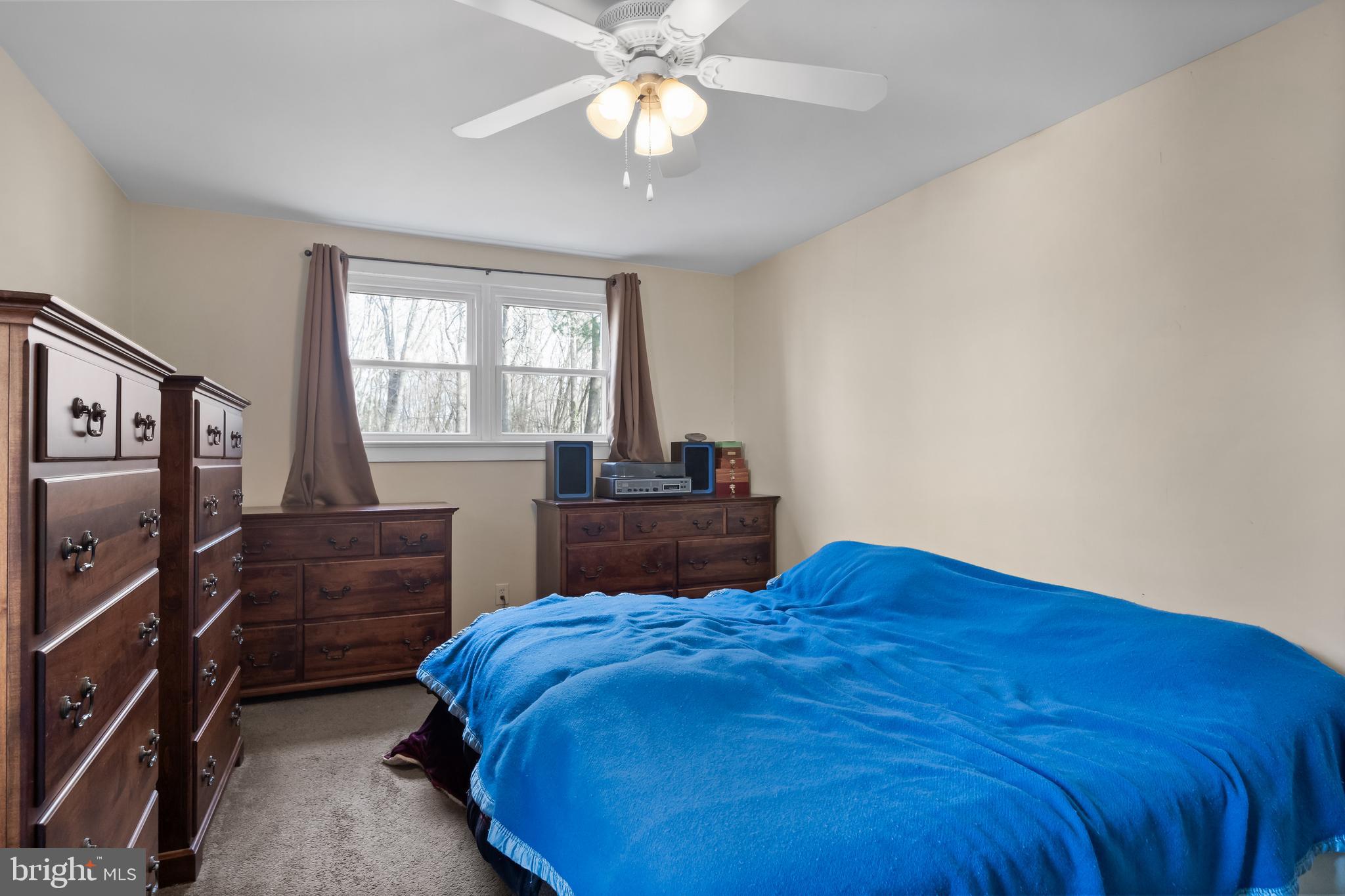 116 Fairmount Avenue Voorhees, NJ 08043 - Photo 16 of 37 a bedroom with a bed and a chandelier
