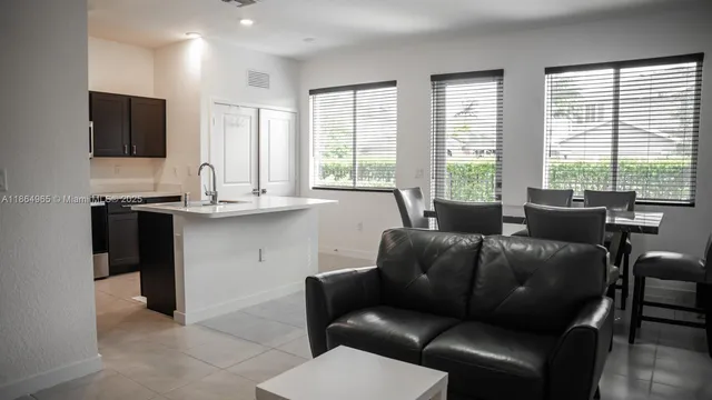 a living room with furniture a large window and a flat screen tv
