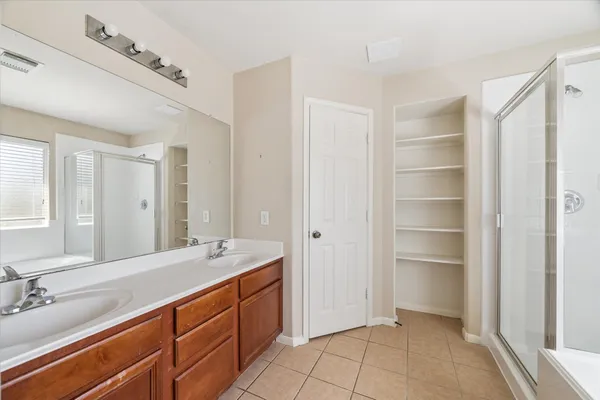 a spacious bathroom with a double vanity sink mirror and double
