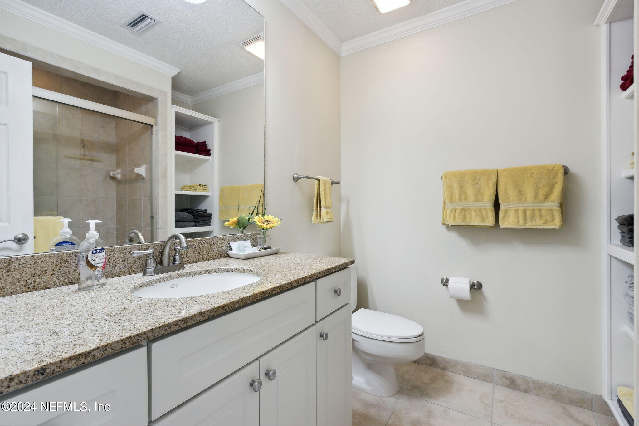 3327 Sea Marsh Road Fernandina Beach, FL 32034 - Photo 19 of 39 a bathroom with a granite countertop toilet sink and mirror