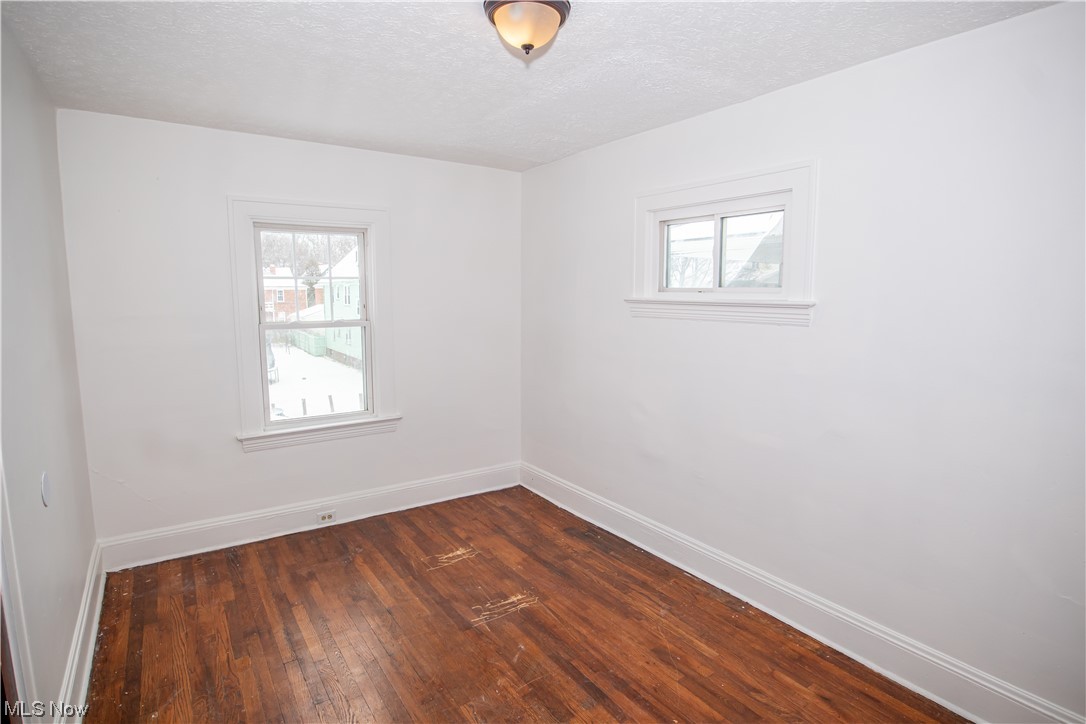 16315 Nela View Road Cleveland, OH 44112 - Photo 19 of 24 Unfurnished room with dark hardwood / wood-style floors and a textured ceiling