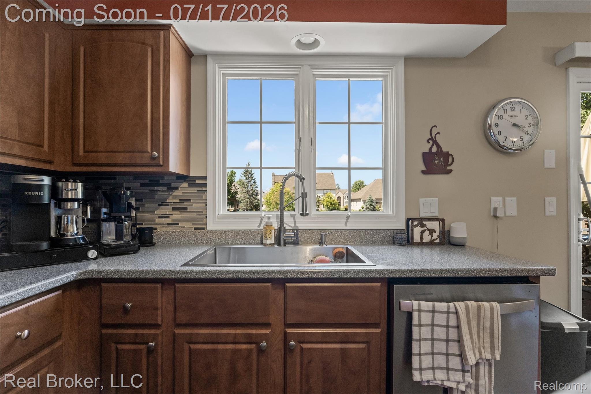 45192 Thornhill Road Canton, MI 48188 - Photo 9 of 34 Kitchen featuring wood cabinetry, speckled countertops, a stainless steel sink with a gooseneck faucet, a tile backsplash, and a large window with grilles