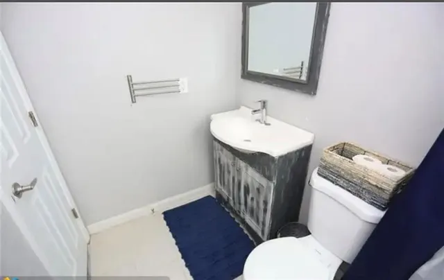 a bathroom with a sink toilet a mirror and bathtub