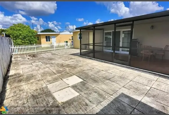 a view of backyard with large tree