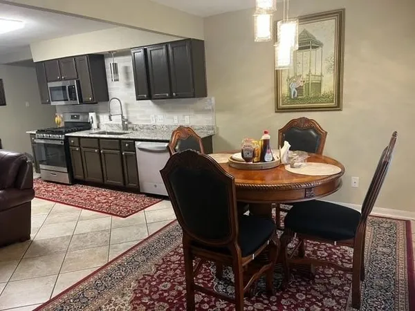a kitchen with a dining table and chairs