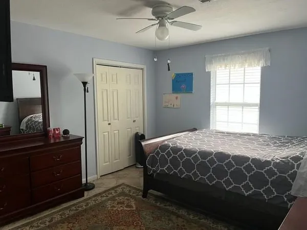 a bedroom with a bed and a dresser