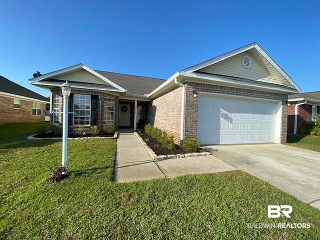 22713 Respite Lane Foley, AL 36535 - Photo 1 of 35 Ranch-style house with a garage and a front lawn