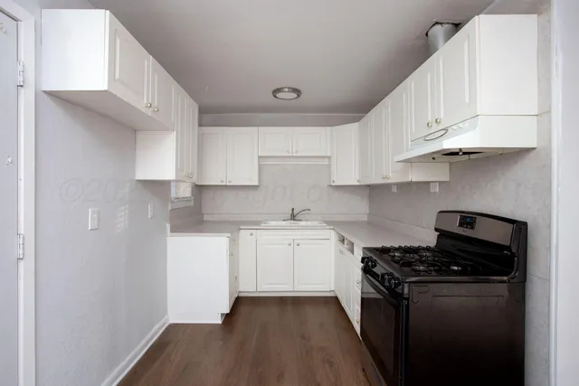 a kitchen with stainless steel appliances a sink stove and cabinets