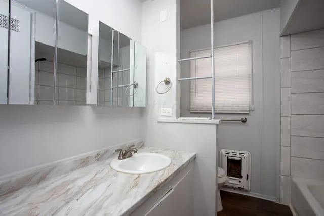 a bathroom with a sink and a mirror