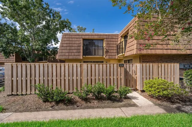 a view of a house with a small yard and plants