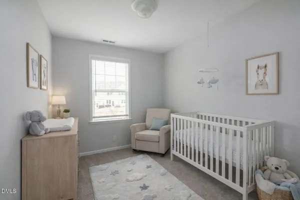 a bedroom with furniture and a window