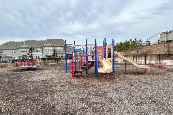 a view of outdoor space with playground and green space