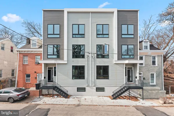 a couple of cars parked in front of a building
