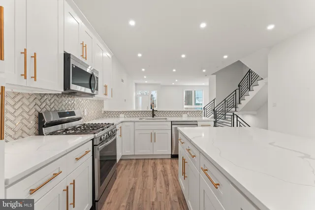 a kitchen with a sink stove and microwave