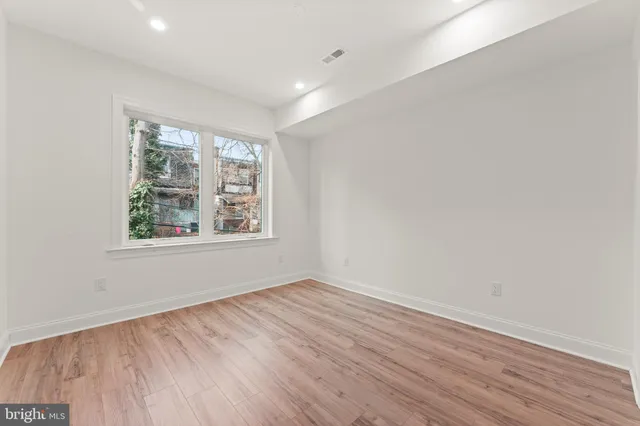 wooden floor in an empty room with a window