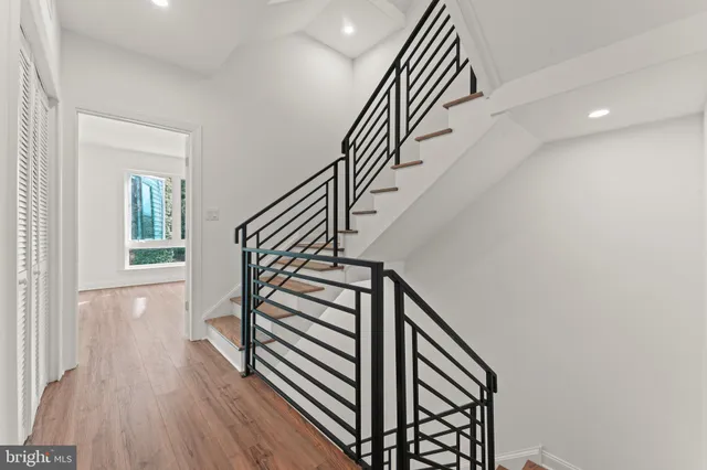 a view of entryway and hall with wooden floor