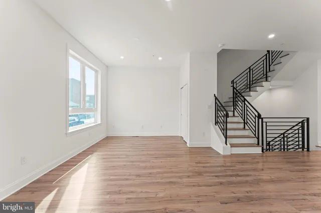 a view of entryway and hall with wooden floor