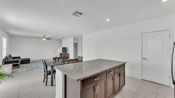 a kitchen that has a table and chairs in it