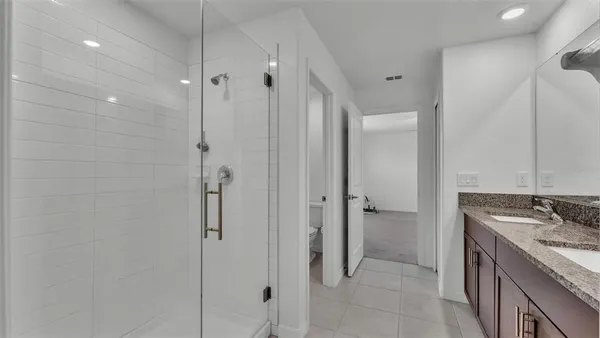 a bathroom with a granite countertop sink mirror and shower