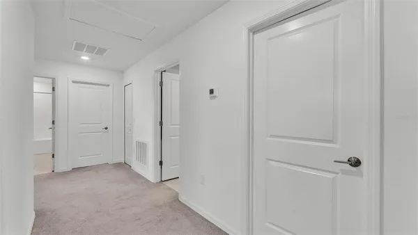 a view of a closet area with ceiling fan