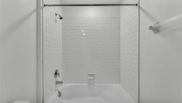 a bathroom with a shower and a bathtub
