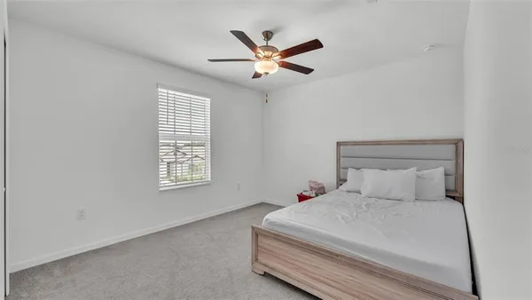 a bedroom with a bed and window