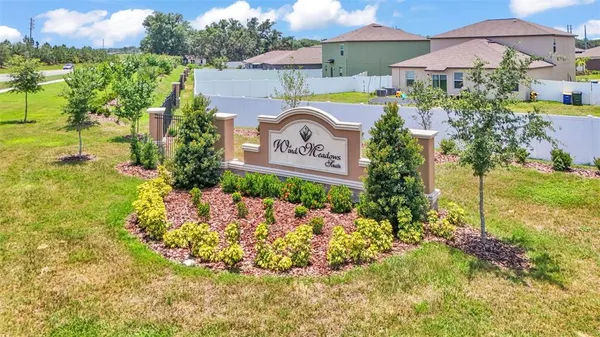 a view of sign board with flower around
