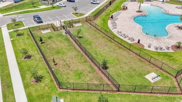 an aerial view of a house with garden space and lake view