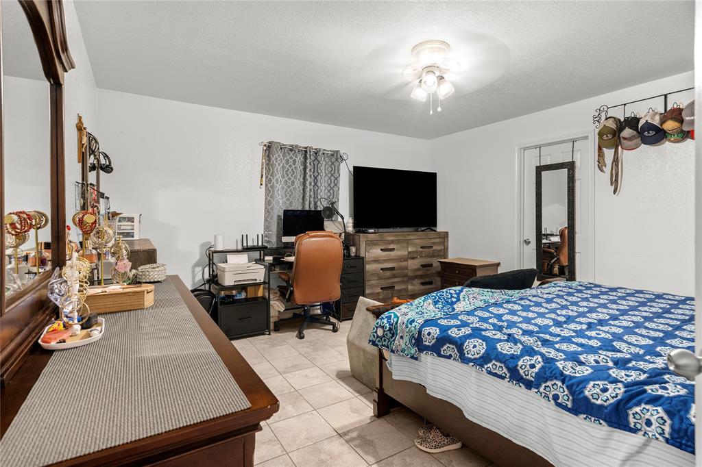 420 Whitney Court Rio Vista, TX 76093 - Photo 13 of 25 a bedroom with a bed and a flat tv screen on the dresser