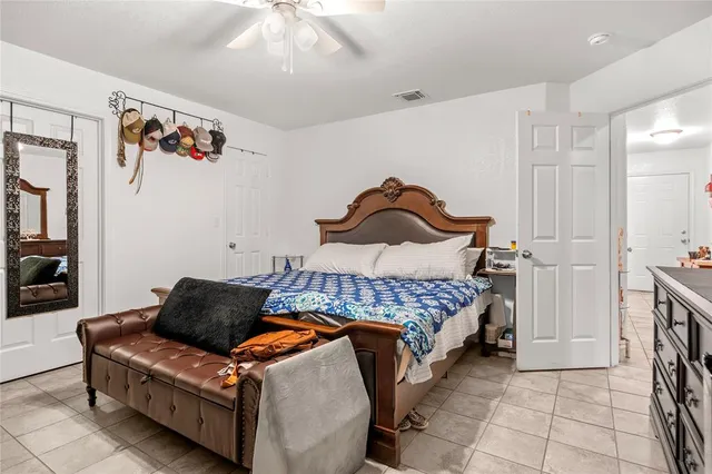 a bedroom with a bed and a painting on the wall