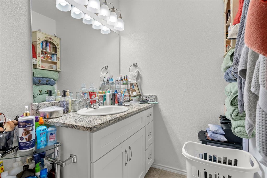 420 Whitney Court Rio Vista, TX 76093 - Photo 16 of 25 a bathroom with a sink a vanity and a mirror