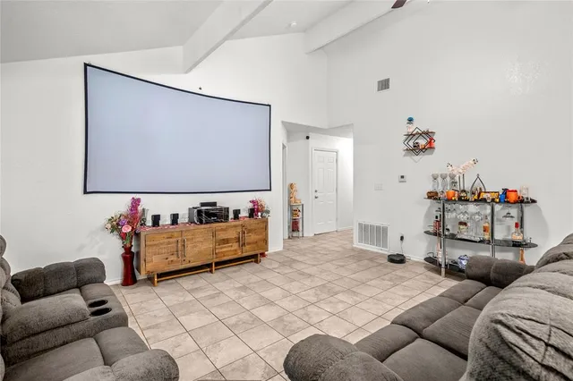 a bedroom with furniture and a flat screen tv