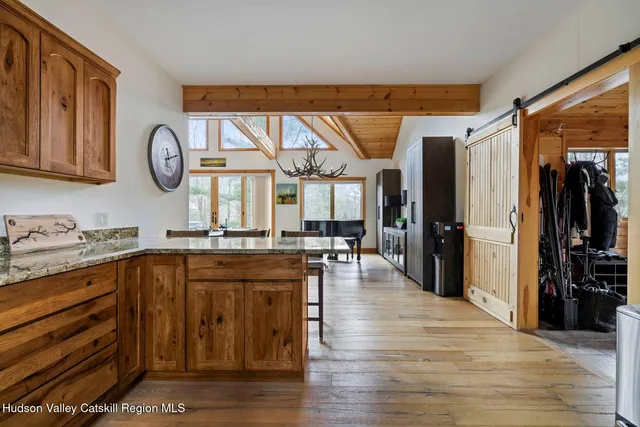 a dining room with stainless steel appliances kitchen island granite countertop a dining table and chairs