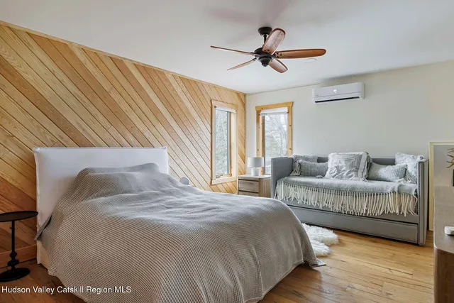 a bedroom with two beds and a window
