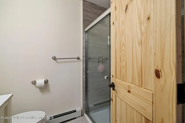 a living room with furniture a flat screen tv and a window