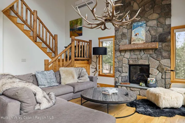 a living room with furniture a table and a fireplace
