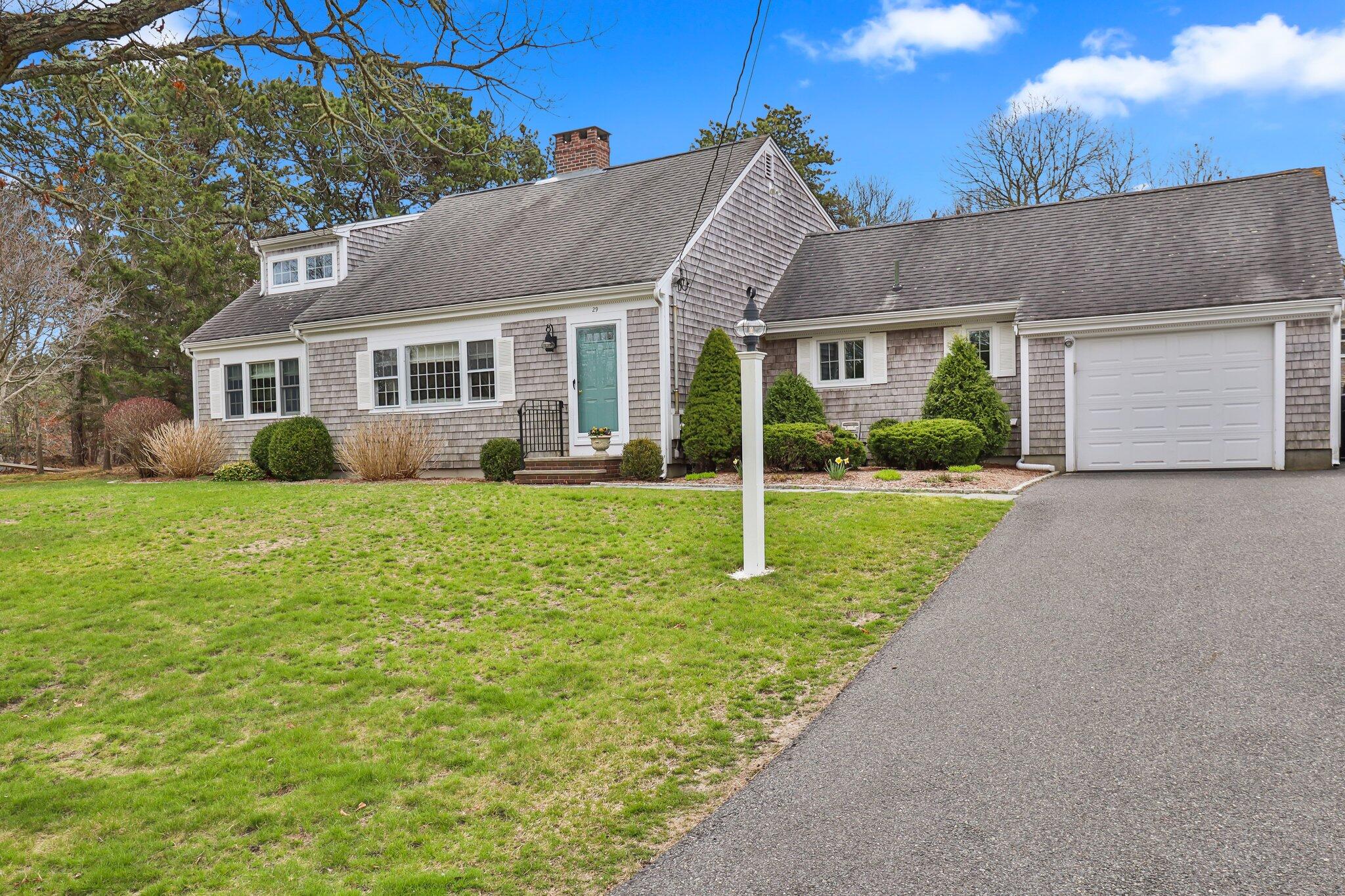a front view of a house with garden and porch