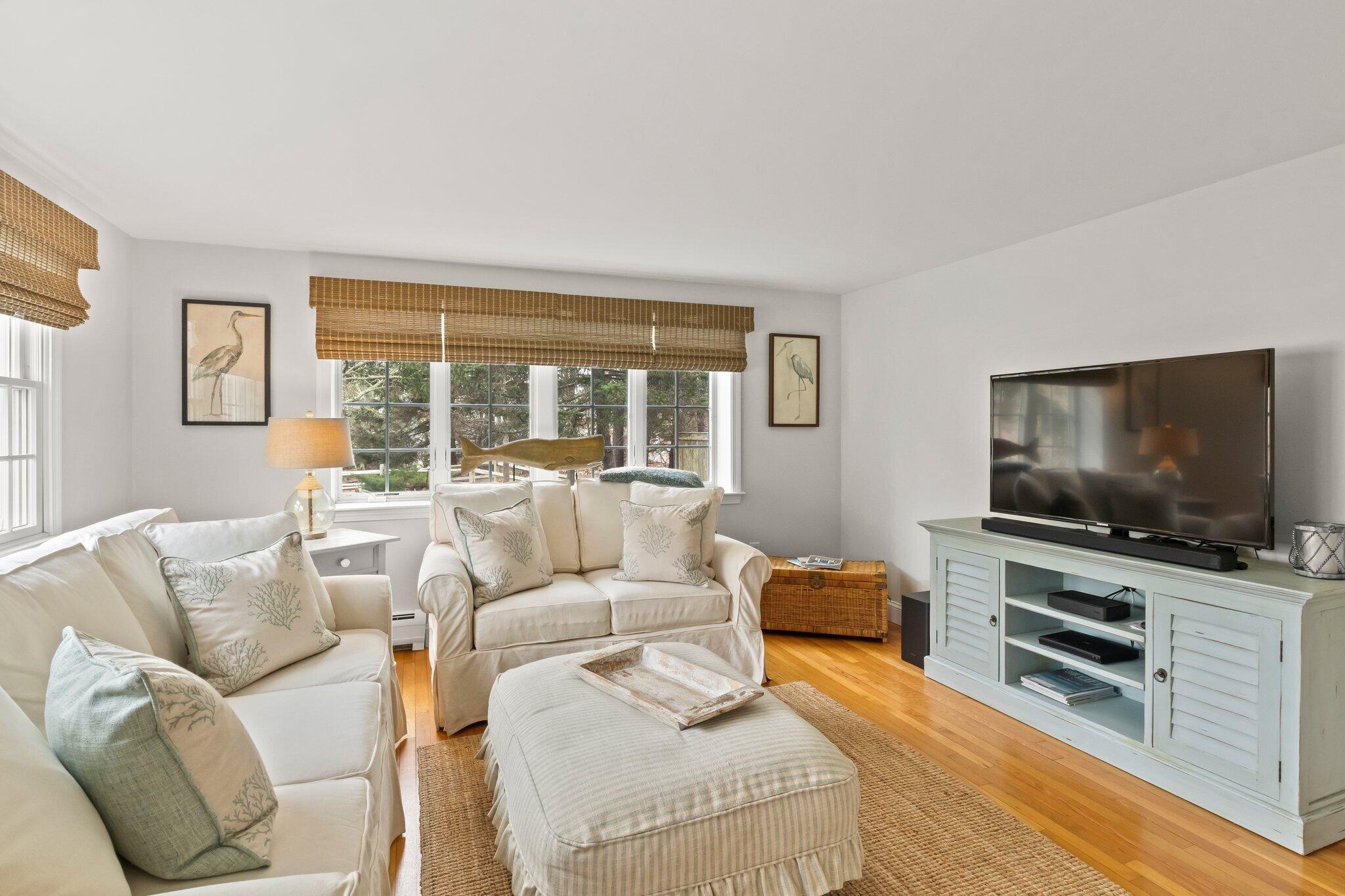 29 Jesse Eldredge Road Harwich, MA 02645 - Photo 16 of 56 a living room with furniture and a flat screen tv